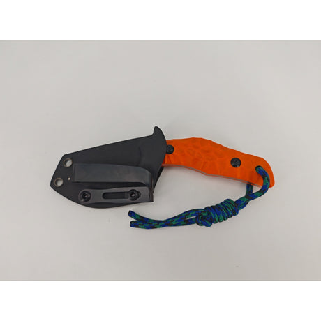 Rückseite der orangefarbenen T Rex Kralle mit Clip sichtbar an der Scheide

