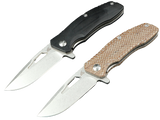 SCHATTENGRAD Summit – Two open folding knives with broad blades and black and light brown handles.